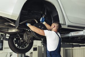 a man repairing a car in a car mechanic workshop